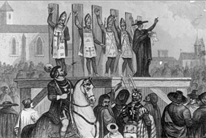 'Heretics' nailed by the hand to wooden posts, and wearing penitants' hats and tabards (