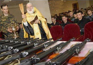 A Christian priest blessing army guns in Syria, 2012