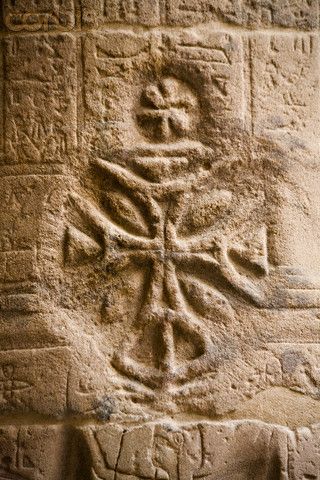 Christian cross carved into Egyptian hieroglyphics at Temple of Isis at Philae, in southern Egypt